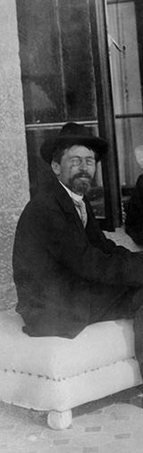 Anton Chekhov and Leo Tolstoy sitting together on a bench in Yalta, Crimea in 1901, both elderly men in dark clothing against a backdrop of arched windows